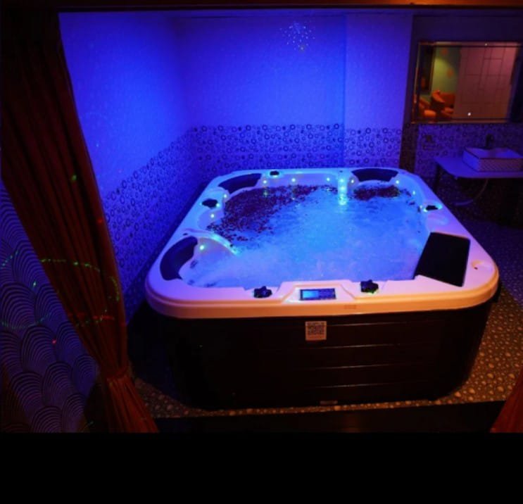 VIP Jacuzzi tub with blue LED lighting at Phoenix International Spa Whitefield
